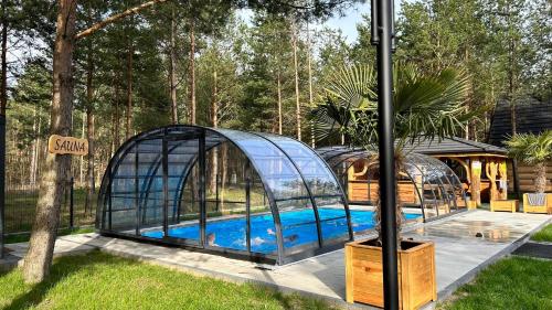 a greenhouse with a swimming pool in it at OŚRODEK U POLAKA nowoczesna stodoła 