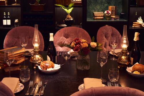 a table in a restaurant with a table set with wine bottles at MJ's in Malmö