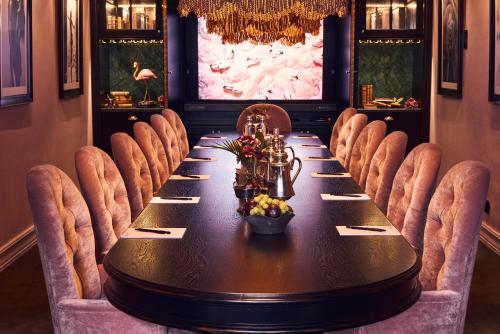 a dining room with a long table and chairs at MJ's in Malmö
