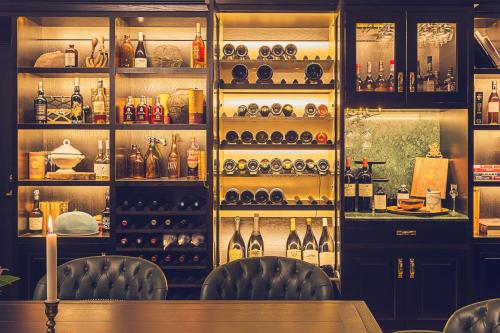 a bar with two chairs and bottles of wine at Hotel Pigalle in Gothenburg