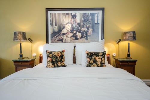 a bedroom with a white bed with two lamps at MJ's in Malmö