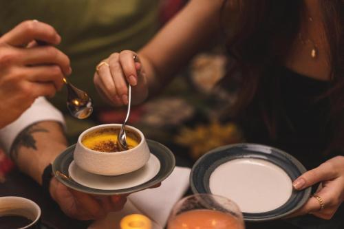 a person eating a cup of coffee with a spoon at Hotel Pigalle in Gothenburg