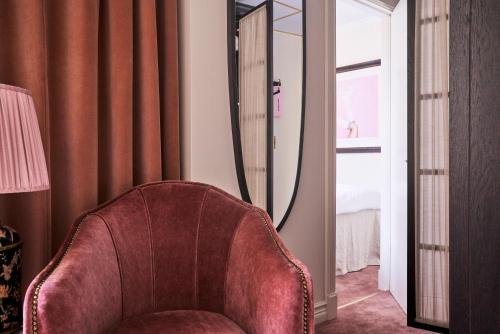 a living room with a chair and a mirror at MJ's in Malmö