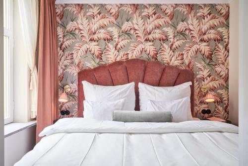 a bedroom with a large bed with a red headboard at MJ's in Malmö