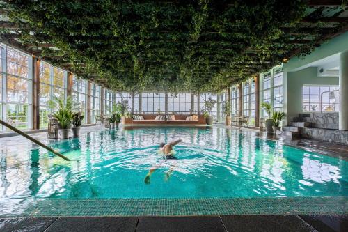 a person swimming in a pool in a building at Ystad Saltsjöbad in Ystad