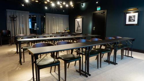 a group of tables and chairs in a room at Steam Hotel in Västerås