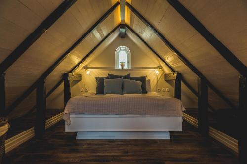 a bedroom with a large bed in a attic at Villa Strandvägen in Ystad