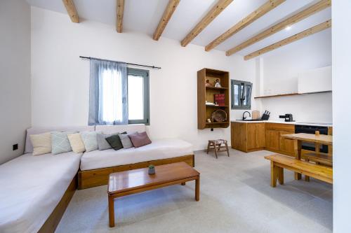 a living room with a couch and a table at ANGONI SUITES in Kardamaina