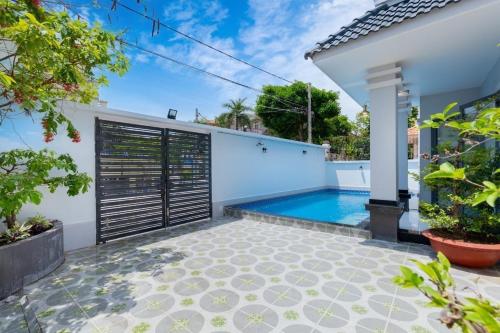 a swimming pool in the backyard of a house at Hoàng My Villa D3 in Vung Tau