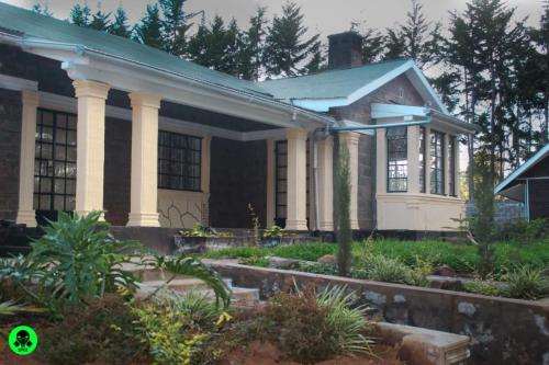 a house with a garden in front of it at TURI HAVEN COTTAGE in Molo