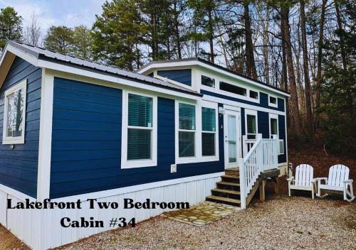 a blue and white tiny house with two chairs at Long Cove Resort and Marina in Charlotte