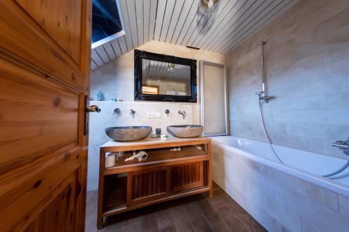 Baumberger Rheinterrassen في Baumberg: حمام مع مغسلتين وحوض استحمام