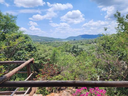 a view from the top of a hill with trees and flowers at Mountain Haven Hideaway in Buffelspoort