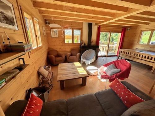 a living room with a couch and a table at Individual chalet for up to 12 people maximum in Les Contamines-Montjoie