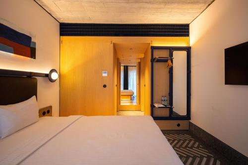 a bedroom with a white bed and a mirror at Stay Lab Taksim in Istanbul