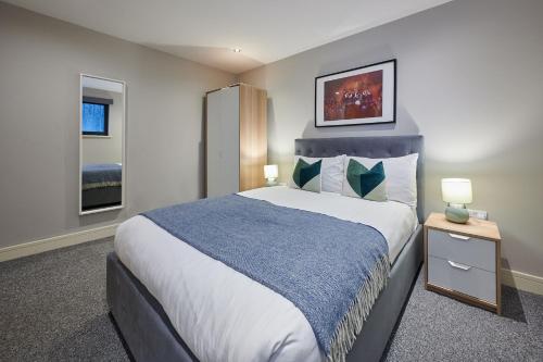 a bedroom with a large bed and two windows at Host & Stay - Ropewalks Abode in Liverpool