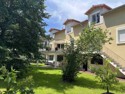 a large house with a yard at Le Jardin du Dolaizon in Le Puy en Velay