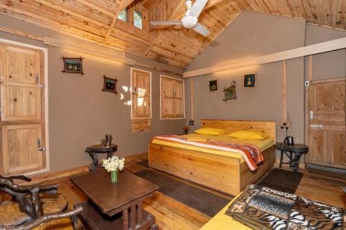 a bedroom with a bed and a wooden ceiling at NotOnMap - H2O House in Chamba