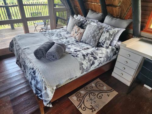 a bed with pillows on it in a room at Mountain Haven Hideaway in Buffelspoort