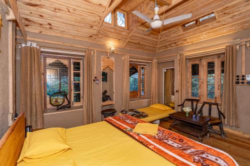 a bedroom with two beds and a wooden ceiling at NotOnMap - H2O House in Chamba