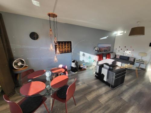 a living room with a table and chairs and a couch at Tichnich Appartement - 2 bedrooms - 1 min away from train station in Annemasse