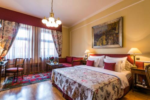 a hotel room with a bed and a couch at Golden Well in Prague