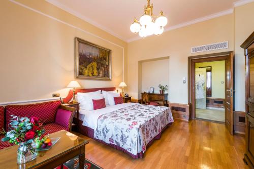 a hotel room with a bed and a couch at Golden Well in Prague