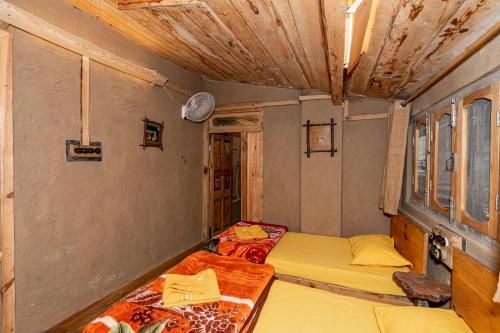 a bedroom with two beds in a room at NotOnMap - H2O House in Chamba