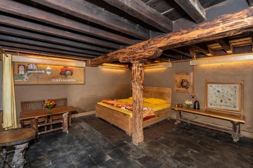 a bedroom with a wooden bed and a desk at NotOnMap - H2O House in Chamba