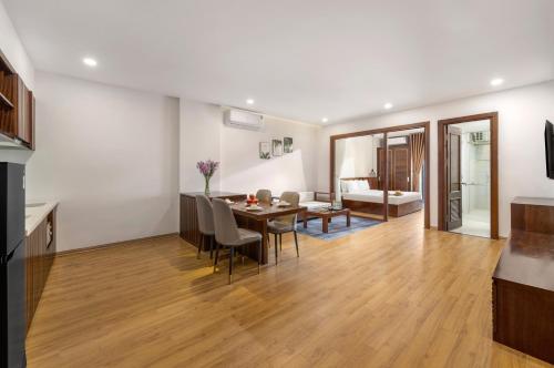 a dining room and living room with a table and chairs at Dana Boutique Hotel & Apartment in Da Nang