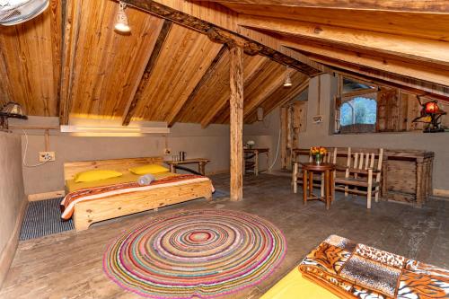 a bedroom with a bed and a table and chairs at NotOnMap - H2O House in Chamba