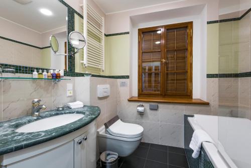 a bathroom with a sink and a toilet at Golden Well in Prague