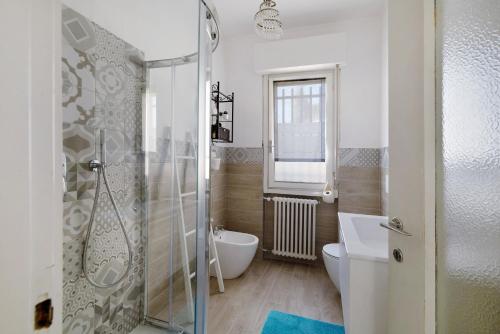 a bathroom with a shower and a toilet and a sink at Appartamento Bella Vista in Premeno