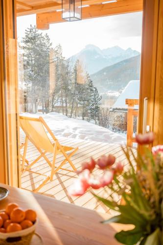 a view of a balcony with a table and a chair at Chalet Ski Académie - Serre Chevalier in Saint-Chaffrey
