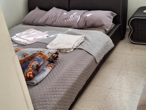 a bed with two pillows on top of it at 2 bedroom apartment in Makenzi in Larnaka