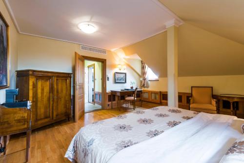 a bedroom with a large bed and a desk at Golden Well in Prague