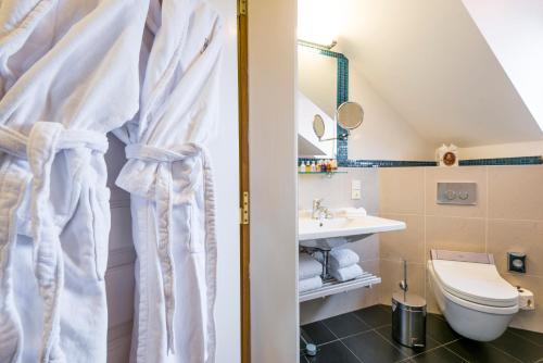 a bathroom with a toilet and a sink at Golden Well in Prague