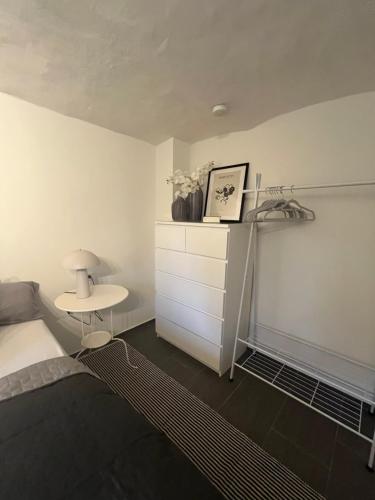 a bedroom with a bed and a nightstand and a table at kleine Flora - Apartment in Minden