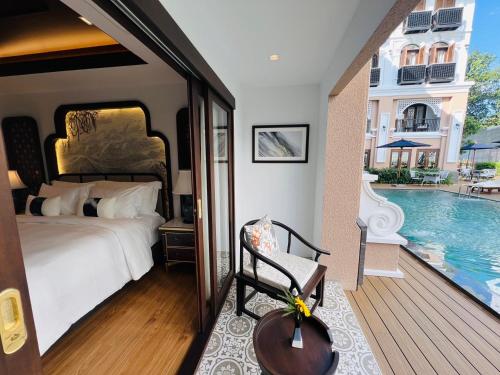 a bedroom with a bed and a swimming pool at CHINO@NIMMAN Luxury Boutique Hotel in Chiang Mai