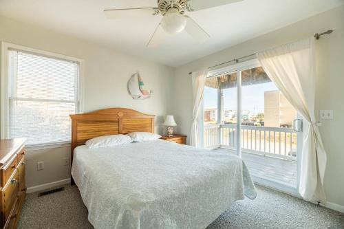 a bedroom with a bed and a large window at Ocean View's in Kill Devil Hills