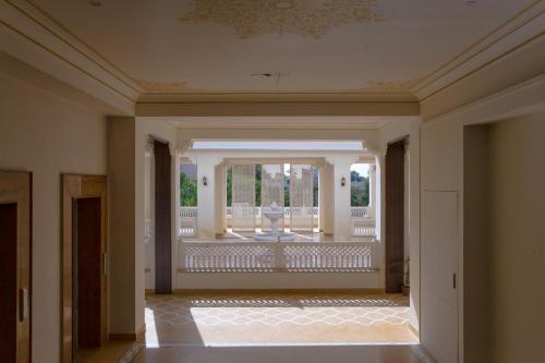 an empty hallway of a house with a balcony at Grand Uniara A Heritage Hotel in Jaipur