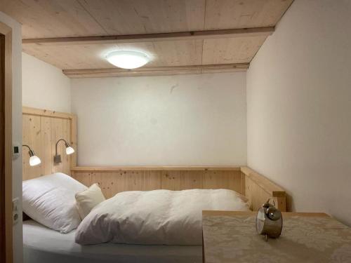 a bedroom with a white bed and two lights at Albliebe am Rosenbühl in Münsingen