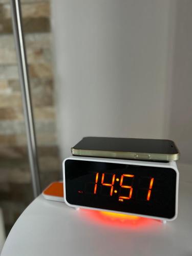 an alarm clock sitting on top of a white table at Mein Appartement Hürth Köln in Cologne