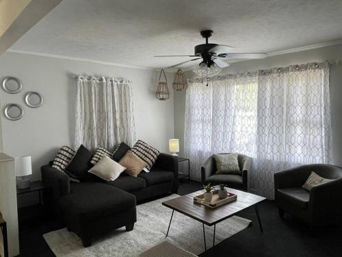a living room with a couch and a table at 1 king/2queen bd home next to big park in Lexington