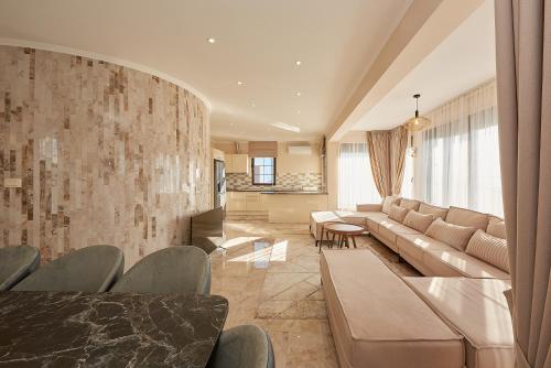 a living room with a couch and a table at Sunbreeze Delux Vilas in Budva