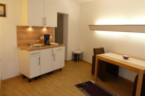 eine Küche mit einem Waschbecken und einem Holztisch in der Unterkunft Seehütte Ferienwohnung 104 in Cuxhaven