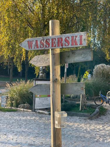 a wooden sign that reads westsexick in a park at Mein Appartement Hürth Köln in Cologne