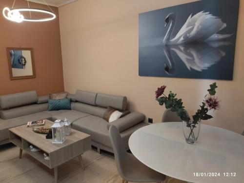 a living room with a couch and a table at Swan Paradise Glyfada Apartment in Athens