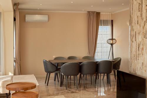 a dining room with a table and chairs at Sunbreeze Delux Vilas in Budva