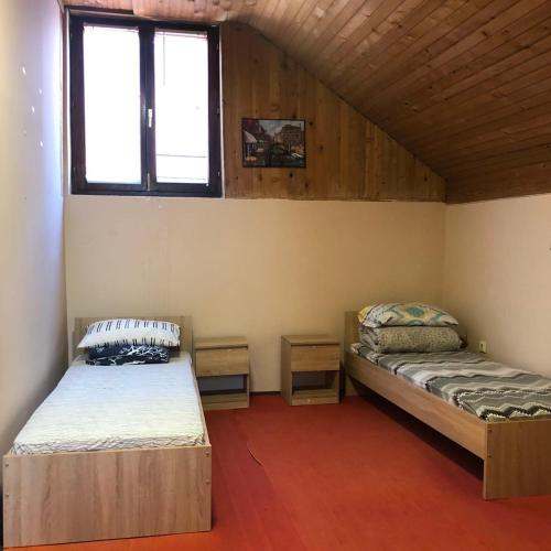 a room with two beds and a window in it at Two single beds' room in sremski karlovic center in Sremski Karlovci